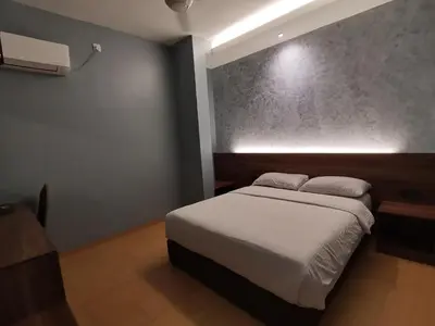 a bedroom with a large bed in a room at Lumut Hotel in Lumut