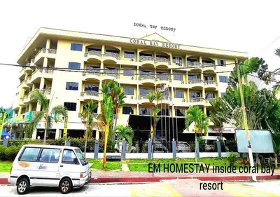 a white van parked in front of a building at EM HOMESTAY(Coral Bay 3Room Apartment) in Pangkor