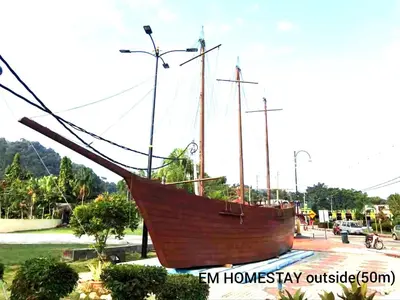 a large wooden boat on display in a park at EM HOMESTAY(Coral Bay 3Room Apartment) in Pangkor