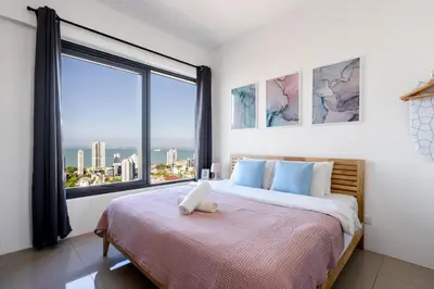 a bedroom with a bed with a large window at De Pastel Studio - SeaView at 218 Tropicana NEAR Komtar Food Heaven with Netflix & TV Box in George Town