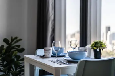 a table with two wine glasses and a bowl at De Pastel Studio - SeaView at 218 Tropicana NEAR Komtar Food Heaven with Netflix & TV Box in George Town