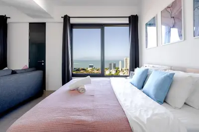 a bedroom with a large bed with a large window at De Pastel Studio - SeaView at 218 Tropicana NEAR Komtar Food Heaven with Netflix & TV Box in George Town