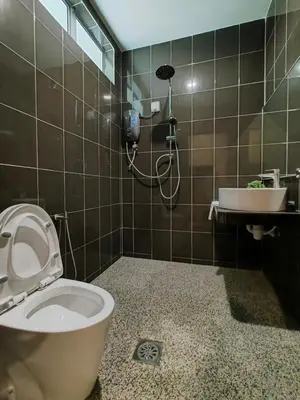 a bathroom with a toilet and a sink at DURIAN HILL VILLA in Gua Musang