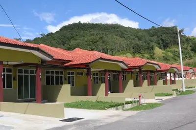 a row of houses with a mountain in the background at DURIAN HILL VILLA in Gua Musang