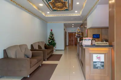 a lobby with two couches and a christmas tree at Hotel Rose Crest Hill, Cameron Highlands in Cameron Highlands