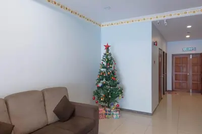 a christmas tree in a living room with a couch at Hotel Rose Crest Hill, Cameron Highlands in Cameron Highlands