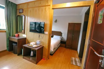 a hotel room with a bed and a mirror at Hotel Rose Crest Hill, Cameron Highlands in Cameron Highlands