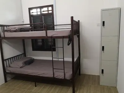 two bunk beds in a room with two doors at Homey Hostel, Ipoh Town in Ipoh