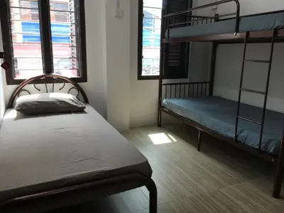 a bedroom with two bunk beds and two windows at Homey Hostel, Ipoh Town in Ipoh