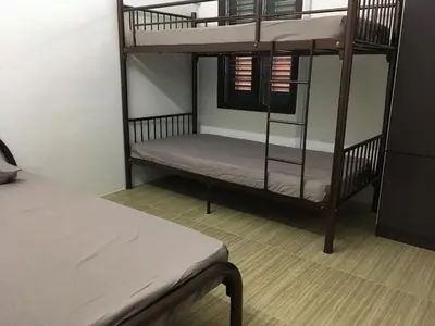a room with two bunk beds and a bed at Homey Hostel, Ipoh Town in Ipoh