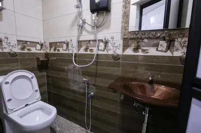 a bathroom with a toilet and a sink and a shower at Lee Luxury Home USM Penang in Gelugor