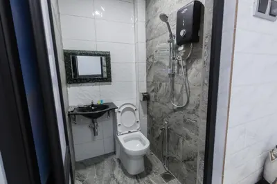 a small bathroom with a toilet and a shower at Lee Luxury Home USM Penang in Gelugor