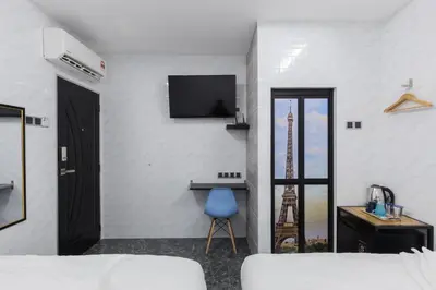 a room with a bed and a tv on a wall at Lee Luxury Home USM Penang in Gelugor
