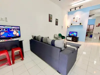 a living room with a couch and a tv at Kampar Sakura 2 Landed in Kampar