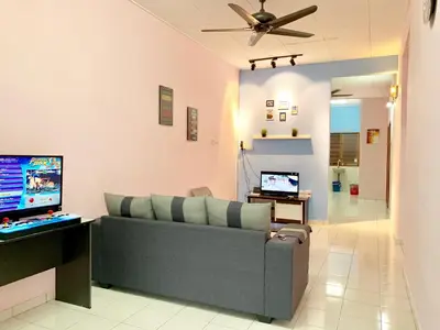 a living room with a couch and a television at Kampar Sakura 2 Landed in Kampar