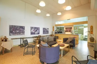 a living room with couches and tables and a kitchen at Bellevue The Penang Hill Hotel, Bukit Bendera in Ayer Itam