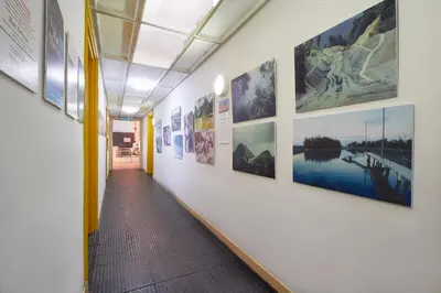 a hallway with a row of pictures on the wall at Bellevue The Penang Hill Hotel, Bukit Bendera in Ayer Itam