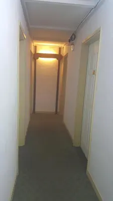 an empty hallway with a door and a light on at Bellevue The Penang Hill Hotel, Bukit Bendera in Ayer Itam