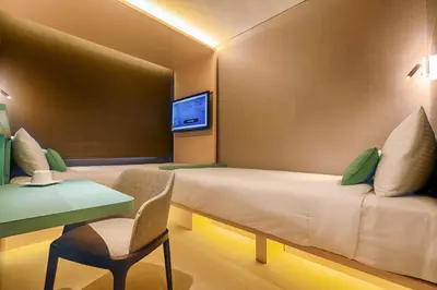 a hotel room with a bed and a table and a desk at The Upper House, Batu Kawan in Batu Kawan