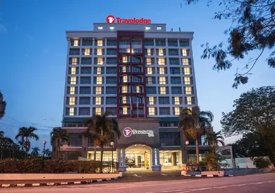 a hotel with a sign on top of a building at Travelodge Ipoh in Ipoh