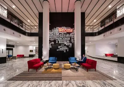 a man sitting in a waiting room in a lobby at Travelodge Ipoh in Ipoh