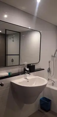 a bathroom with a sink and a large mirror at Travelodge Ipoh in Ipoh