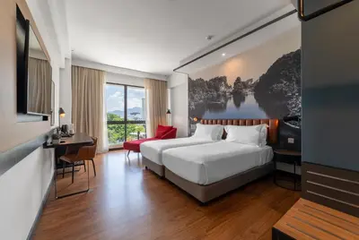 a hotel room with a bed and a large window at Travelodge Ipoh in Ipoh