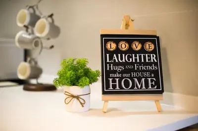a sign sitting on a counter next to a plant at Casa Orient @ Macalister 218 ❈中路218东方之家 3BR 8PAX in George Town