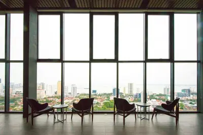 a room with chairs and tables in front of a large window at Casa Orient @ Macalister 218 ❈中路218东方之家 3BR 8PAX in George Town