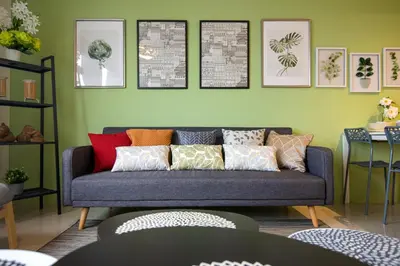 a living room with a couch with colorful pillows at Casa Orient @ Macalister 218 ❈中路218东方之家 3BR 8PAX in George Town