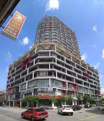 a tall building with cars parked in a parking lot at Ipoh Octagon Premium Suites by Verve in Ipoh