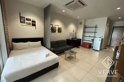 a bedroom with a bed and a couch in a room at Ipoh Octagon Premium Suites by Verve in Ipoh