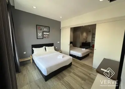a hotel room with two beds and a mirror at Ipoh Octagon Premium Suites by Verve in Ipoh