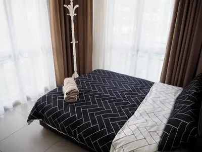 a bedroom with a bed with a cross on it at The PENT Duplex Cameron in Tanah Rata