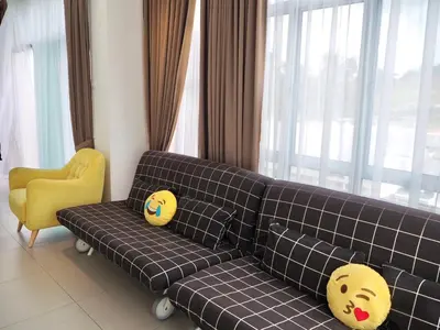 a living room with a couch and a yellow chair at The PENT Duplex Cameron in Tanah Rata