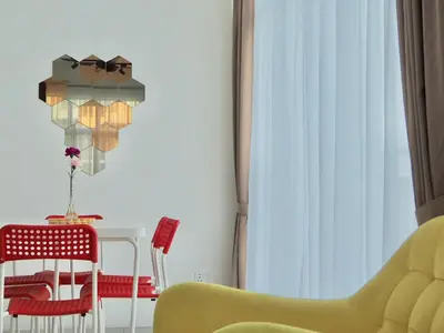 a dining room with a table and a yellow chair at The PENT Duplex Cameron in Tanah Rata