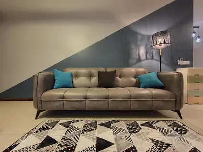 a living room with a brown couch with blue pillows at Landmark By Katana 4BR Romantic Seaview Homestay Gurney\u65e0\u654c\u6d77\u666f\u56db\u623f\u5957\u623f in Tanjong Tokong