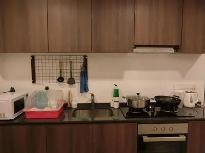 a kitchen counter with a sink and a microwave at Landmark By Katana 4BR Romantic Seaview Homestay Gurney\u65e0\u654c\u6d77\u666f\u56db\u623f\u5957\u623f in Tanjong Tokong