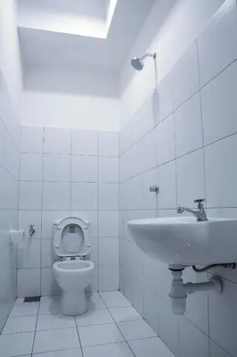 a white bathroom with a toilet and a sink at Landmark By Katana 4BR Romantic Seaview Homestay Gurney\u65e0\u654c\u6d77\u666f\u56db\u623f\u5957\u623f in Tanjong Tokong