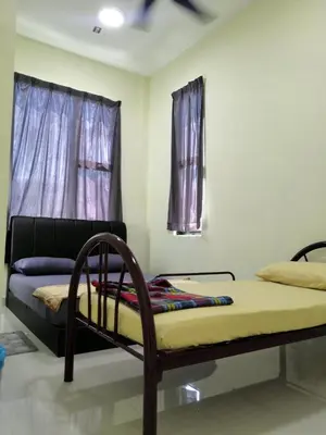 a bed in a room with a window at WeJDAN INN BALIK PULAU, PENANG ISLAND in Balik Pulau
