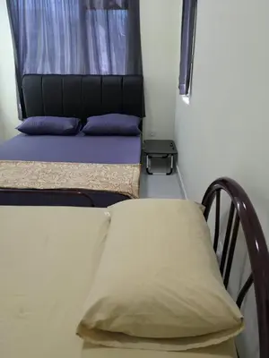 a bedroom with a bed and a window with a pillow at WeJDAN INN BALIK PULAU, PENANG ISLAND in Balik Pulau
