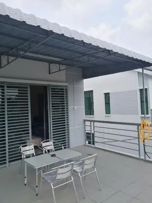 a patio with a table and chairs on a balcony at WeJDAN INN BALIK PULAU, PENANG ISLAND in Balik Pulau