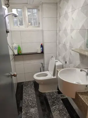 a bathroom with a toilet and a sink at Hills Sanctuary Retreat, B7-3A-2 with WI-FI in Bukit Fraser