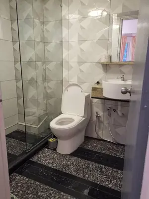 a bathroom with a toilet and a sink at Hills Sanctuary Retreat, B7-3A-2 with WI-FI in Bukit Fraser