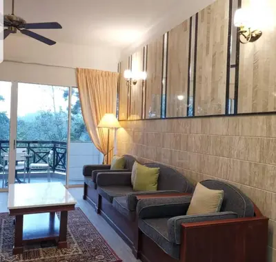 a living room with two couches and a ceiling fan at Hills Sanctuary Retreat, B7-3A-2 with WI-FI in Bukit Fraser