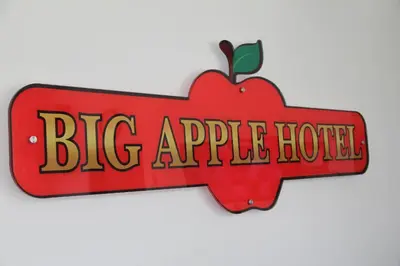 a big apple hotel sign with an apple on it at Big Apple Hotel in Kulim