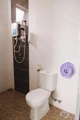 a bathroom with a toilet and a shower at OK FAMILY VILLA in Ipoh