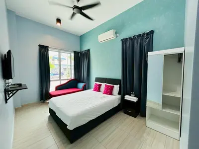 a bedroom with a bed with pink pillows at OK FAMILY VILLA in Ipoh