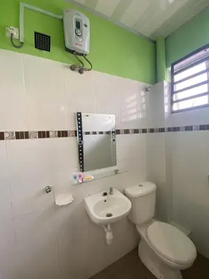 a bathroom with a white toilet and a sink at HILLVIEW HOMESTAY in Tanah Rata
