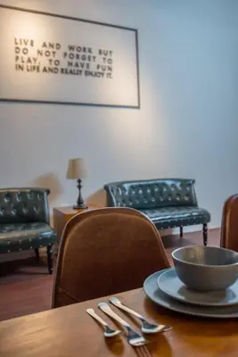 a table with a bowl on top of it with chairs at Abu Siti George Town in George Town